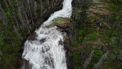 Aerial-View-of-Virginia-Falls-in-Landscape-of-Glacier-National-Park,-Montana-USA,-Tilt-Up-Drone-Shot