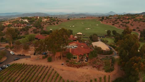 Air-view-of-vineyards,-clubhouse,-and-golf-course-facilities