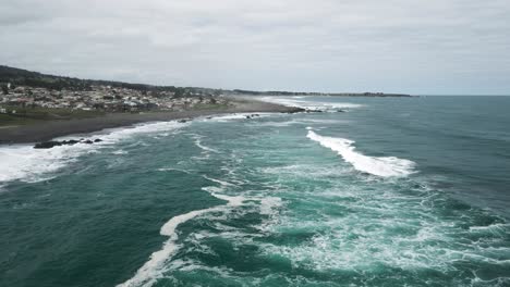 Aerial-view-of-the-waves-of-pichilemu-on-a-cloudy-day