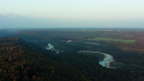 Panning-shot-over-a-rural-landscape-with-the-curvy-Isar-river-next-to-Schäftlarn-in-Bavaria,-Germany