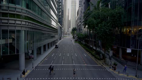 Office-workers-crossing-the-street-at-traffic-light,-Robinson-Road-,-Central-business-district-downtown-Singapore