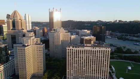 Aerial-view-around-the-city-center-of-Pittsburgh,-during-golden-hour---orbit,-drone-shot