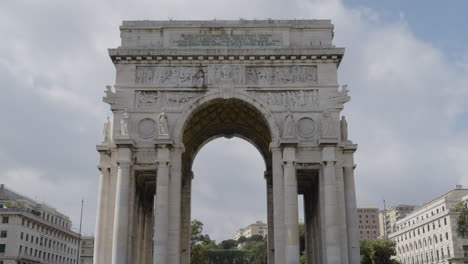 Arco-Della-Vittoria-in-city-of-Genoa,-tilting-up-view-with-cloudy-sky