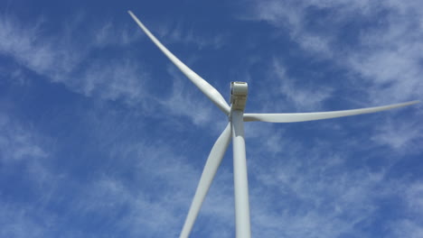 Windmill-turbine-spinning-against-a-cloudy-sky