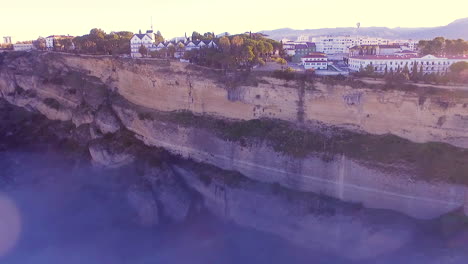 Aerial-view-of-Ronda-cliff-and-city-during-fall-with-beautiful-foggy-morning-sea-of-clouds-during-sunrise