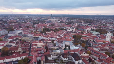 Panoramic-aerial-circling-view-of-Vilnius-old-town-on-cloudy-afternoon,-Lithuania