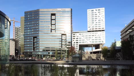 Timelapse-at-Utrecht-central-train-station-with-people-going-up-and-coming-down-the-large-staircase-leading-to-the-modern-buildings-reflecting-the-sun-that-shines-on-the-exterior-glass-facades