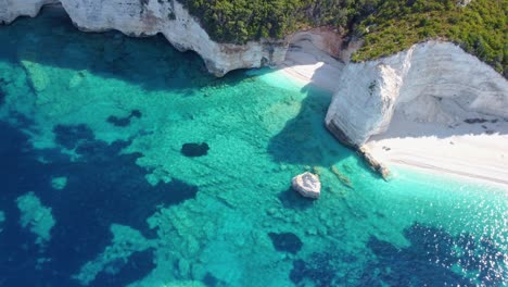 Aerial-video-of-blue-lagoon-with-rocky-coastline,-Kefalonia,-Greece