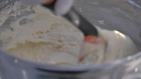 Close-up-gimbal-shot-of-hands-with-spatula-mixing-dough