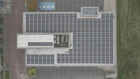 Bird's-Eye-View-Of-Solar-Panels-On-Building-Rooftop-In-Park-West-Business-Park,-Dublin,-Ireland---drone-shot