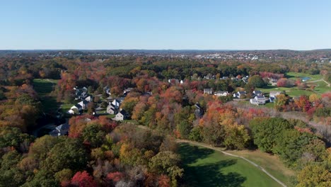 Township-of-Haverhill-with-autumn-tree-colors,-drone-ascend-view