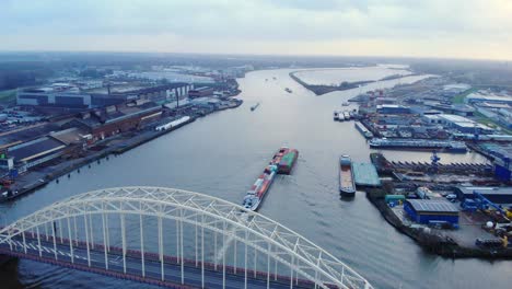 Aerial-View-Over-Brug-over-de-Noord-Of-Circle-Inland-Container-Vessel-Going-Past