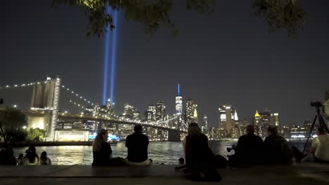 People-Sit-And-View-September-11th-Memorial-Lights-In-New-York-City
