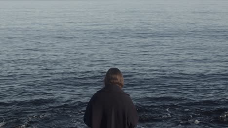 Mysterious-woman-looking-at-the-ocean-in-slow-motion-and-4K-at-25fps
