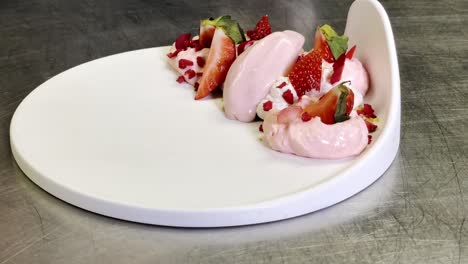 Last-touch-of-an-incredible-healthy-dessert-composed-of-strawberries-and-ice-cream-close-up
