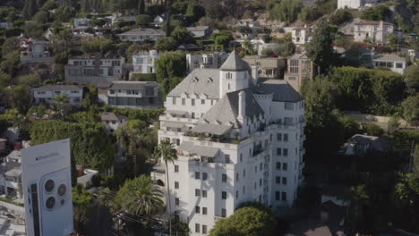Flying-by-the-Chateau-Marmont-in-Los-Angeles-with-the-houses-of-The-Hollywood-Hills-in-the-background