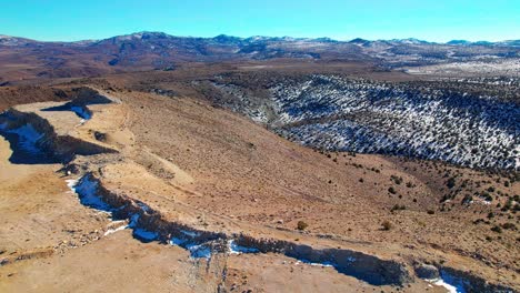 Aerial-view-over-desert-mountains-landscape-with-a-little-snow-in-Nevada,-dry-arid-climate