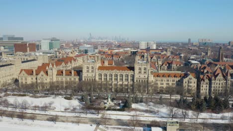 Fixed-Aerial-View-of-University-of-Chicago-Campus-with-Chicago-Skyline-in-Background-on-Cold-Winter-Day