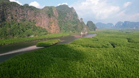 Drone-flying-over-Ao-Thalane-mangroves-and-river-in-Krabi-Thailand-on-a-sunny-day-overlooking-the-mountains