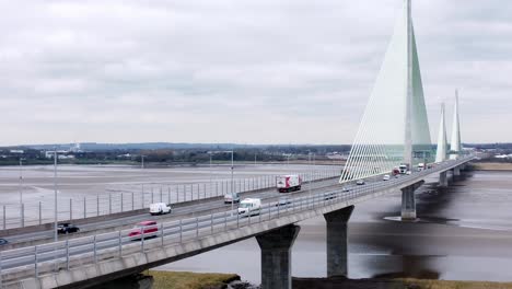 Mersey-gateway-landmark-aerial-view-above-toll-suspension-bridge-river-crossing-slow-descending-shot