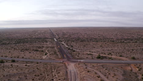 Aerial-pull-back-of-an-intersection-in-an-Arizona-desert-at-golden-hour