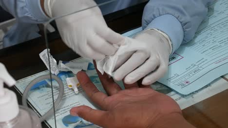Yogyakarta,-Indonesia---Feb-26,-2022-:-Health-worker-is-poking-a-patient's-finger-with-tool-needle-before-proceed-with-the-blood-test-measurement