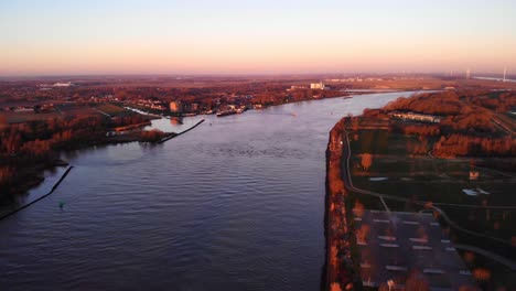 Aerial-Landscape-View-Over-Puttershoek-With-Autumnal-Sunrise-Fall-Colours-With-Oude-Maas-Running-Through
