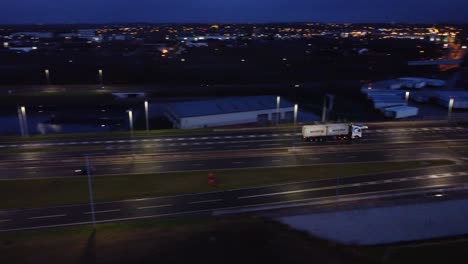 Aerial-view-modern-illuminated-quiet-highway-lanes-road-intersection-traffic-track-truck-right