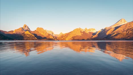 Riaño-snowy-peak-during-sunrise-reflection-in-water-reservoir