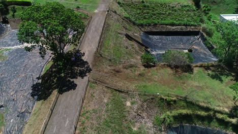 aerial-video-of-sewage-treatment-plant,-residential-retention-ponds-around-green-area-in-residential-condominium,-costa-rica