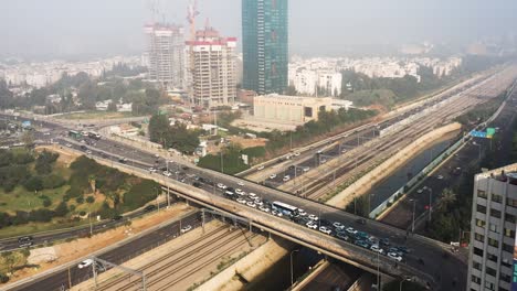 Der-Verkehr-Auf-Einer-Überführung-Wartet-Darauf,-Dass-Die-Ampel-Auf-Grün-Wechselt,-Um-Weiterzufahren,-Während-Mehrere-Autos-Unter-Der-Überführung-Auf-Der-Autobahn-A20-In-Tel-Aviv-Am-Autobahnkreuz-La-Guardia-Hindurchfahren
