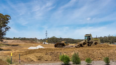 Time-lapse-of-a-dump-truck-and-road-rollers-constructing-the-soil-base-of-a-new-housing-development-road