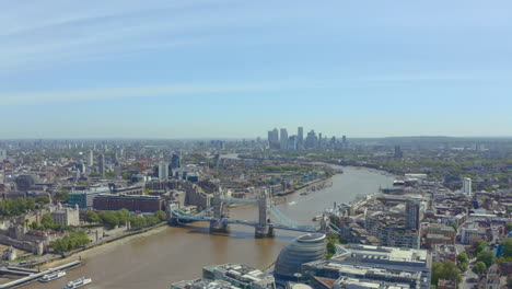 Slider-drone-shot-of-Tower-bridge-and-canary-wharf-on-a-sunny-day
