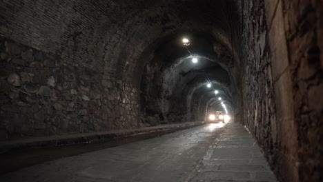Cars-driving-by-the-famous-underground-tunnels-in-Guanajuato,-Mexico
