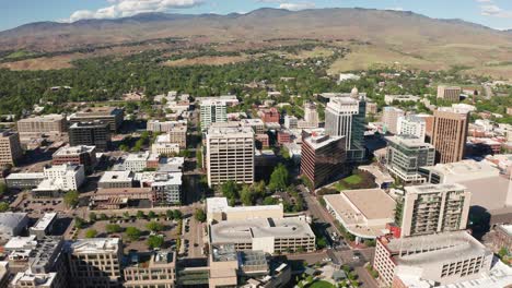 Wide-drone-shot-of-Boise,-Idaho's-downtown-sector-surrounded-by-arid-farmland