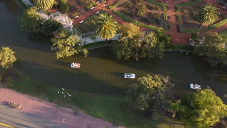 Orbit-aerial-view-of-pedalboats,-Palermo-Lakes,-Buenos-Aires