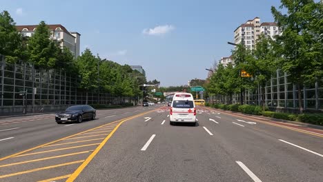 Driver's-POV-Following-An-Ambulance-Driving-In-The-City-Of-Seoul,-South-Korea