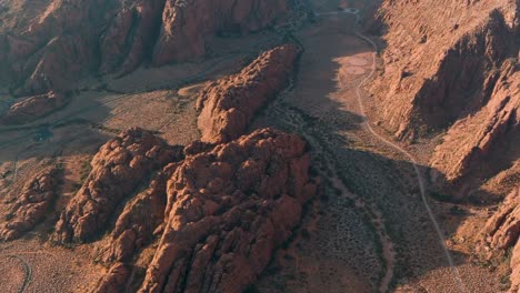 Aerial-at-sunset-of-gold-crested-rocks-in-Snow-Canyon-Sate-Park-