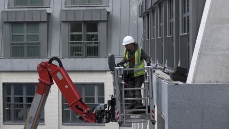 Construction-Worker-with-Safety-Harness-adjusts-Cherry-Picker