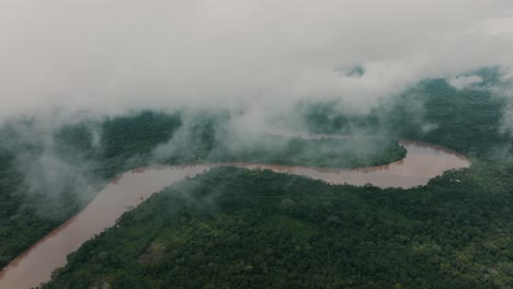 Murky-River-Between-Dense-Amazon-Rainforest-On-Foggy-Day