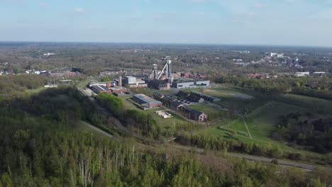 Old-Mining-Tower-in-Belgium,-Approaching-Drone-View-of-Coal-Industry