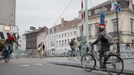 Cyclists-and-pedestrians-during-rush-hour-in-car-free-historic-urban-city-of-Ghent,-Belgium---Static-view