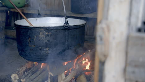 CHEESE-MAKING---The-huge-pot-of-sheeps-milk-over-the-smokey-fire