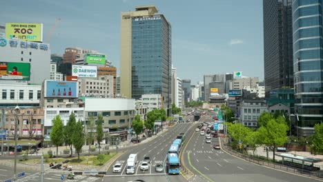 Cars-Stopped-on-Red-Traffic-light-at-Complex-Crossroads-near-Seoul-Station-with-city-panoramic-view