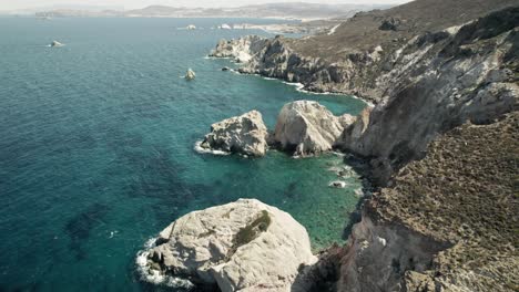 Slowly-moving-past-a-rocky-cliffside-overlooking-the-breathtaking-turquoise-blue-water-of-the-Mediterranean