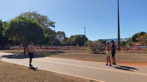 walkers-and-people-with-their-dogs-enjoy-one-of-the-many-roads-through-the-beautiful-city-park-of-brasilia-on-a-sunny-summer-day