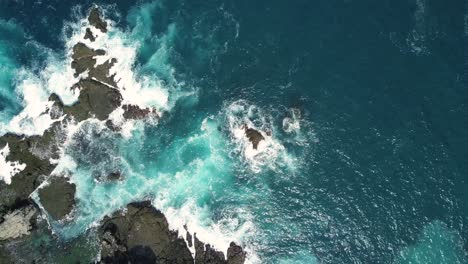 overhead-drone-shot-of-coral-hits-by-the-sea-wave,-siung-beach,-yogyakarta,-Indonesia