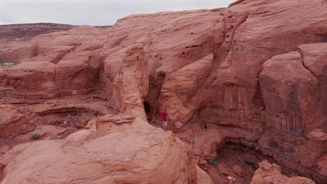 Aerial-view-of-people-exploring-rock-formations-in-Utah