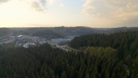 Aerial-view-descending-above-woodland-to-Circuit-De-Spa-Francochamps-racetrack-Stavelot-Belgium