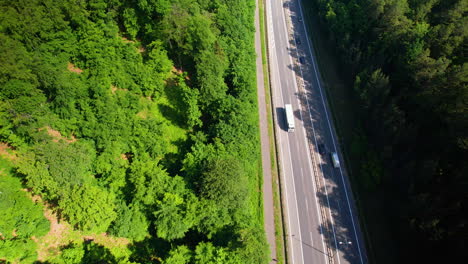 Cars-and-Vehicles-passing-on-Multi-Lane-Highway,-Forest-and-trees-on-both-sides